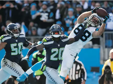  ?? JAMIE SQUIRE/GETTY IMAGES. ?? Greg Olsen of the Carolina Panthers makes a touchdown reception during the second quarter of the NFC Divisional Playoff Game against the Seattle Seahawks at Bank of America Stadium on Sunday in Charlotte, North Carolina.