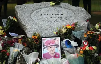  ?? ?? The nation’s rock: Flowers in Ballater by stone marking Diamond Jubilee