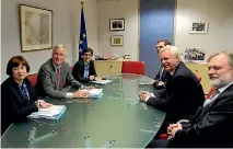  ?? PHOTO: REUTERS ?? Britain’s Brexit secretary David Davis and his team, right, have been criticised for this photo showing them meeting the European Union’s Brexit delegation without any documents.