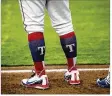  ?? NICK WAGNER / AMERICAN-STATESMAN ?? Express left fielder Willie Calhoun wore Texas Rangers socks against Memphis in April.