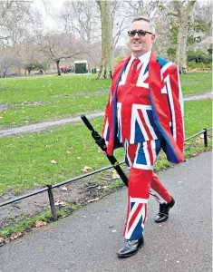  ??  ?? Walking tall: a man in a Union Jack suit in London, the day after the Tories’ victory