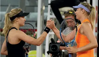  ?? PHOTO: REUTERS ?? Eugenie Bouchard, left, and Maria Sharapova shake hands awkwardly after their three-set struggle.