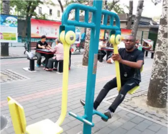  ??  ?? Rocco Nkanga exercises in a park in Beijing