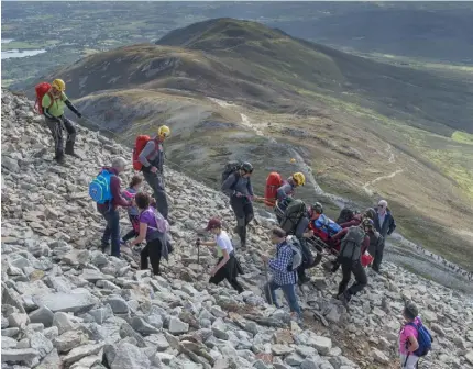  ?? PHOTO: MICHAEL MCLAUGHLIN ?? Ritual focus: Pilgrims make their way up and down the rugged slopes of Croagh Patrick.