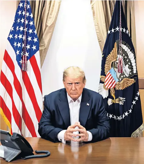  ??  ?? Donald Trump, pictured as he prepared to take a phone call from the vice-president at the Walter Reed National Military Medical Center, has said he is regaining strength. Below, Kayleigh Mcenany also tested positive