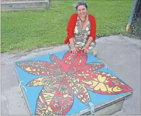  ??  ?? Colourful Dot: Whaea Dot (real name Dot Payne) has colourful ideas to brighten up Maraeroa School – the lids of two sandpits are an example of one idea brought to fruition, which the students took on as their own project.