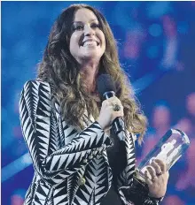  ??  NATHAN DENETTE/THE CANADIAN PRESS ?? Alanis Morissette receives her award from the Canadian Music Hall of Fame during the 2015 Juno Awards.