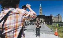  ?? Canadian Press photo ?? Chinese tourists vist Parliament Hill in Ottawa last week as preparatio­ns for Canada Day are underway.