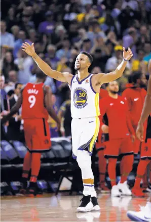  ?? Santiago Mejia / The Chronicle ?? Stephen Curry enjoys a moment in the spotlight. The Warriors’ guard scored 30 points and hit the go-ahead three-pointer in the final minute to subdue the Raptors.