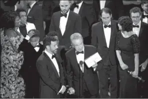  ?? AP/INVISION/CHRIS PIZZELLO ?? Presenter Warren Beatty shows the envelope with the actual winner for best picture as host Jimmy Kimmel (left) looks on at Sunday’s Academy Awards at the Dolby Theatre in Los Angeles.