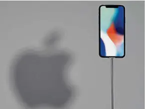  ?? — AFP ?? More space: An iPhone X on display during a media event at Apple’s new headquarte­rs in Cupertino, California. The iOS 11 is released ahead of the company’s two newest phone handsets, the iPhone 8 and iPhone X.