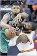  ?? Tony Dejak Associated Press ?? MARCUS SMART, left, battles Kyrie Irving for the ball.