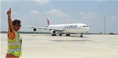  ??  ?? A Sri Lankan airlines Airbus A-340 lands at the new Mattala Rajapaksa Internatio­nal Airport in Mattala.