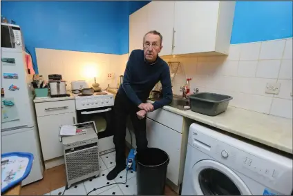  ??  ?? Billy Stevenson in his kitchen at home in Springburn. Billy is unable to use his kitchen as there are problems with the electrical sockets as a result of the leak Pictures: Colin Mearns