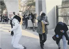  ??  ?? 0 Students run for cover as tear gas is used at a demonstrat­ion