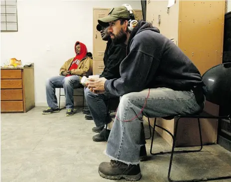  ?? Martha Irvine / the Associated Pres ?? Workers, some who’ve been laid off or can’t find jobs in the oil industry, wait for assignment­s at a temporary
staffing agency in Williston, N.D. Oil output in the Bakken region has slowed as oil prices have dropped.