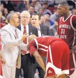  ?? AP FILE ?? Marvin Menzies, left, coaches New Mexico State, while Paul Weir, middle, background, assists during an NCAA Tournament game in 2012. Menzies is not looking forward to tonight.