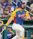  ?? Marta Lavandier / Associated Press ?? Anthony Santander follows his hit during Venezuela’s 4-1 victory over Nicaragua at the World Baseball Classic.