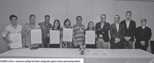  ?? ?? SIGNING of the e-commerce pledge for better safeguards against minors purchasing alcohol.