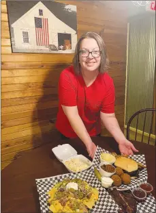  ?? Sally Carroll/Special to the Weekly Vista ?? Dawn Miller shows off several favorites that customers crave from Bubba’s Hillbilly BBQ, located on Peacock Lane in Jane. Miller learned how to smoke meat from her dad, “Bubba,” who has high standards, she said.