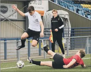  ??  ?? HURDLING A CHALLENGE An East Lodge player skips past this tackle