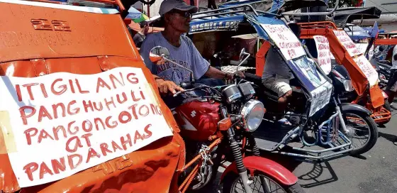  ?? RICHARD A. REYES ?? TRICYCLE and pedicab drivers stage a noise barrage on Bustillos Street in Manila against the Manila Tri-Wheel Ordinance which requires them to pay a fee for the registrati­on of their vehicles.