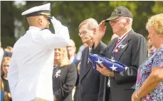  ?? TYGER WILLIAMS/AP ?? Gene D. Costill, brother of Pearl Harbor victim Fireman 3rd Class Harold Kendall “Bud” Costill, salutes after being handed a folded flag during the sailor’s interment at Cedar Green Cemetery.