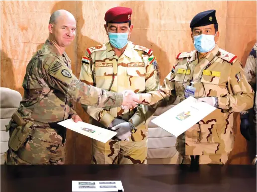  ?? (Abdullah Rashid/Reuters) ?? US LIEUTENANT COLONEL Jace Neuenschwa­nder shakes hands with Iraqi General Mohammed Fadel during a handover ceremony in Nineveh, Iraq, earlier this week.