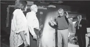  ??  ?? U.S. Republican vice-presidenti­al candidate Mike Pence, centre, and his wife, Karen Pence, inspect damage inside Orange County Republican Party headquarte­rs on Tuesday in Hillsborou­gh, North Carolina. The office was firebombed during the weekend.