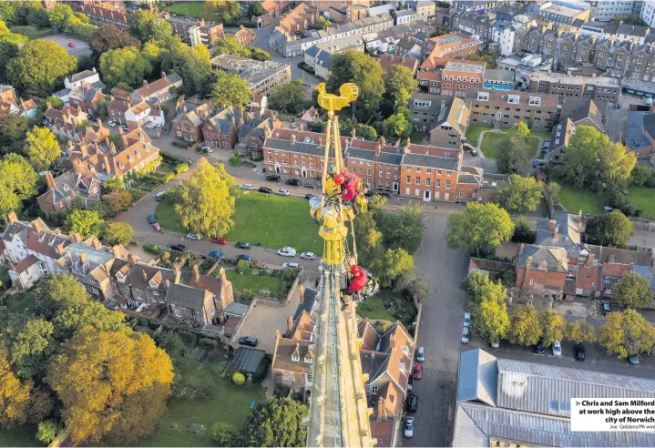  ?? Joe Giddens/PA wire ?? Chris and Sam Milford at work high above the
city of Norwich