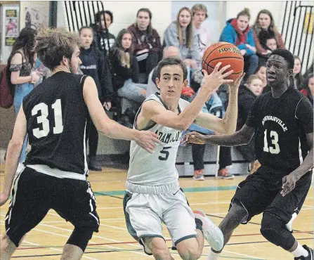  ?? CLIFFORD SKARSTEDT EXAMINER ?? Adam Scott Lions' Zach Deline drives to the net between Bowmanvill­e High School's Jonas Webber (31) and Nathan Buchanan during the opening game of the Green &amp; White Senior Boys' High School Basketball Tournament Friday at Adam Scott Collegiate.