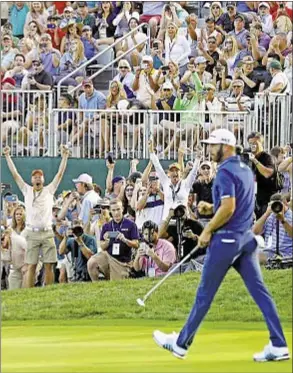  ?? GETTY ?? Crowd cheers as Dustin Johnson hits putt on 72nd hole to force playoff.