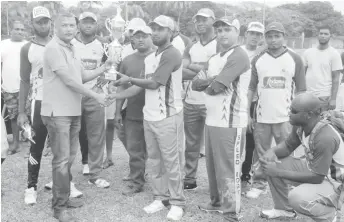  ??  ?? President of the West Demerara Cricket Associatio­n Anand Sanasie hands over the winning trophy to Independen­ce A.