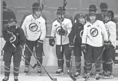  ??  ?? The Coyotes practice during the first day of full training camp on Monday at Gila River Arena in Glendale. NHL owners and players approved an agreement on Friday to resume the season.