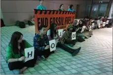  ?? ?? PETER DEJONG — THE ASSOCIATED PRESS Demonstrat­ors hold signs that read “hold the line” and “end fossil fuels” during the COP28U.N. Climate Summit on Monday in Dubai, United Arab Emirates.