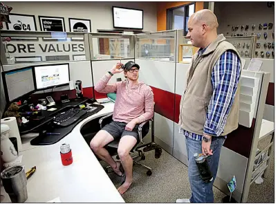  ?? NWA Democrat-Gazette/DAVID GOTTSCHALK ?? David Temple visits Tuesday with employee Roman Johnson at the company’s booking office in Fayettevil­le.