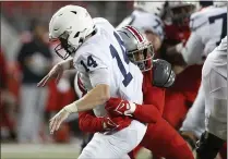  ?? JAY LAPRETE — THE ASSOCIATED PRESS ?? Ohio State defensive lineman Tyreke Smith hits Penn State’s Sean Clifford after he threw a pass in the fourth quarter of the Buckeyes’ 33-24win Saturday night at Ohio Stadium.