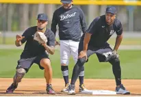  ?? DAVID J. PHILLIP/THE ASSOCIATED PRESS ?? Detroit Tigers infielders Javier Baez, left, and Jonathan Schoop, right, work on drills at second base Sunday during a spring training workout in Lakeland, Fla.