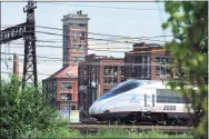  ?? Ned Gerard / Hearst Connecticu­t Media ?? An Amtrak Acela train passes near Crescent Crossing, an affordable housing developmen­t in Bridgeport.