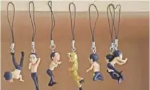  ??  ?? Hanging figurines in various poses at Tokyo-based manufactur­er Kitan Club.