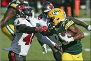  ?? MARK LOMOGLIO — THE ASSOCIATED PRESS ?? Green Bay Packers running back Aaron Jones (33) stiff arms Tampa Bay Buccaneers inside linebacker Devin White (45) during the first half of an NFL football game Sunday, Oct. 18, 2020, in Tampa, Fla.