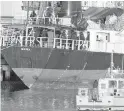  ?? CP ?? Migrants look over the side of MV Sun Sea after it was escorted into CFB Esquimalt on Aug. 13, 2010.