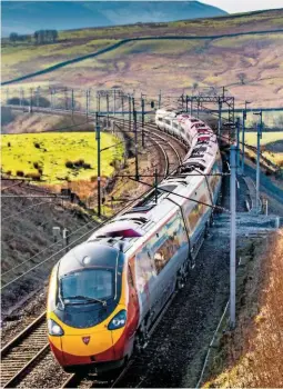  ?? ALAMY. ?? A Virgin Trains West Coast Class 90 Pendolino passes the Cumbrian Fells on April 8 2015. Michael Lyon believes the design of the Pendolinos needs improving, and as for the “pervasive toilet sort of smell”!