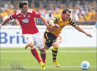  ?? FM4489174, top; FM4489218, above. Buy these pictures from kentonline.co.uk ?? Top, Bobby-Joe Taylor bursts through against Wrexham. Above, Stones team-mate Alex Flisher tries to make up ground