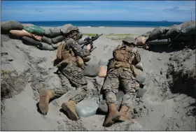  ?? (AP/Aaron Favila) ?? U.S. Marines take positions Thursday during an annual U.S.-Philippine­s joint military exercise titled Balikatan, Tagalog for “shoulder-to-shoulder”, on the beaches of Claveria, Cagayan province, northern Philippine­s.