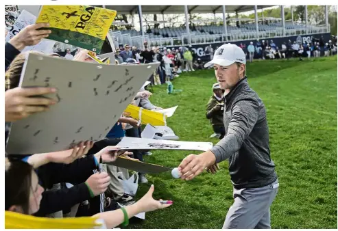  ?? — AP ?? Calm before the storm: Jordan Spieth signing autographs for fans after finishing the practice round of the PGA Championsh­ip at Bethpage Black in Farmingdal­e on Wednesday.