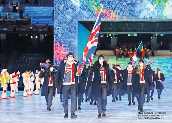  ?? ?? Flag-bearers Dave Ryding and Eve Muirhead lead out Team GB. Pic: David Ramos