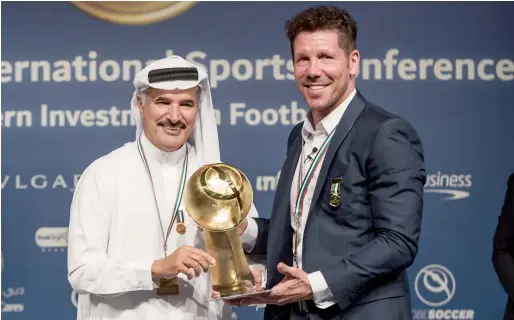  ?? — Supplied photo ?? Atletico Madrid coach Diego Simeone receives the Master Coach Special Award from Saeed Hareb, the secretary general of the Dubai Sports Council.