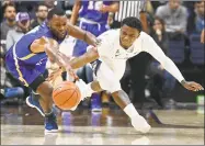  ?? Jessica Hill / Associated Press ?? Morehead State’s A.J. Hicks, left, and UConn’s Christian Vital chase down a loose ball during the first half of Thursday’s game in Storrs.