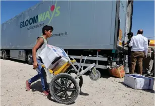  ?? (Reuters) ?? HUMANITARI­AN AID is prepared to be delivered to Syria yesterday, in the town of Ramtha, Jordan.